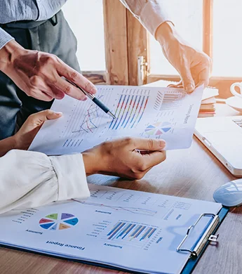 two persons looking at statistics on a paper